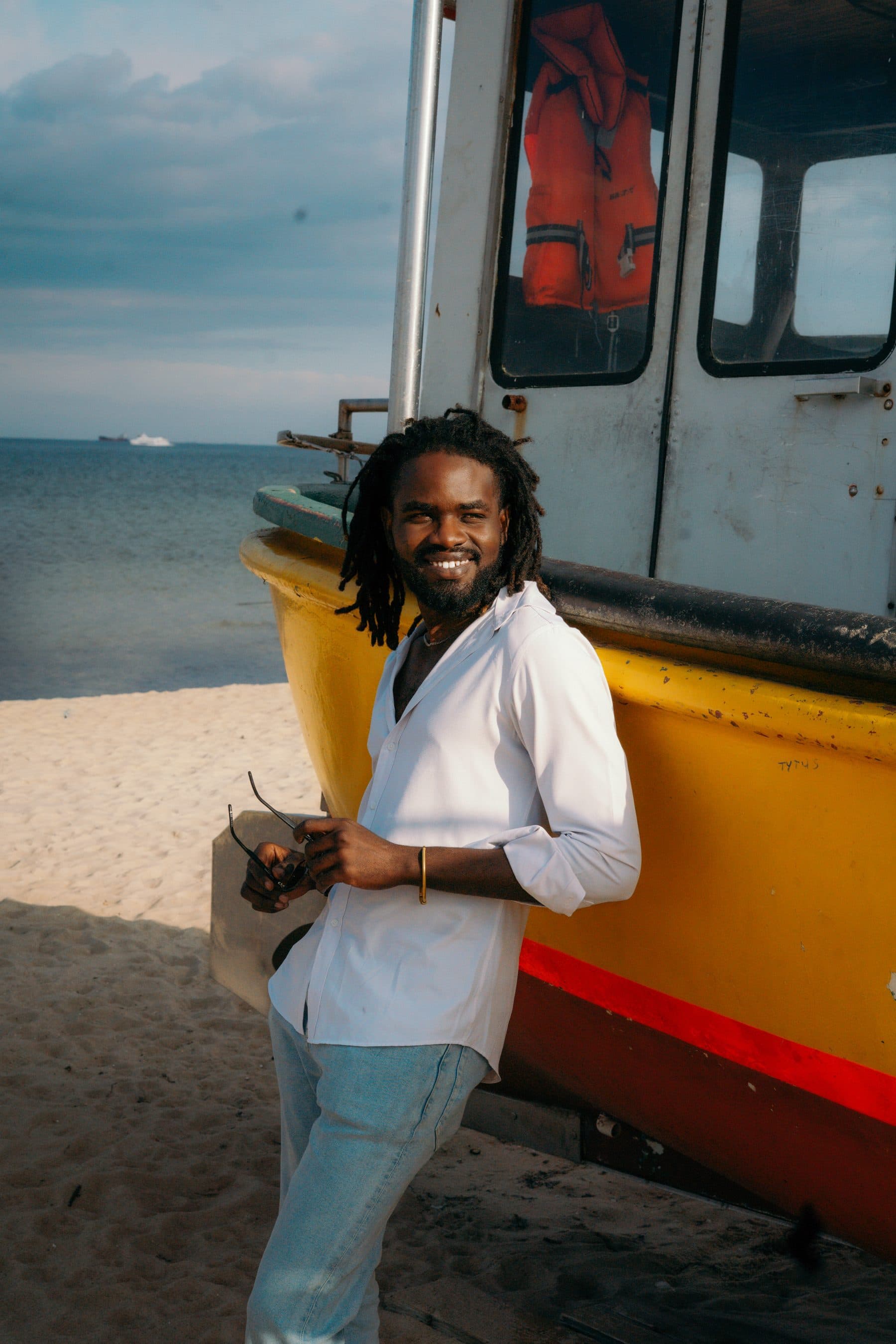 Prince Blaise, photographer and director, smiling on the beach in Gdansk